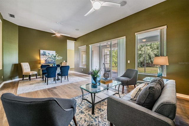 living room featuring ceiling fan and hardwood / wood-style floors