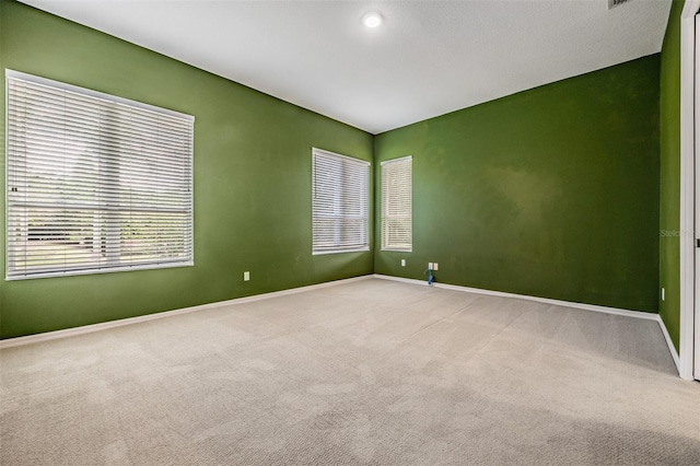 unfurnished room featuring carpet