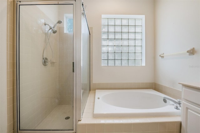 bathroom with vanity and separate shower and tub