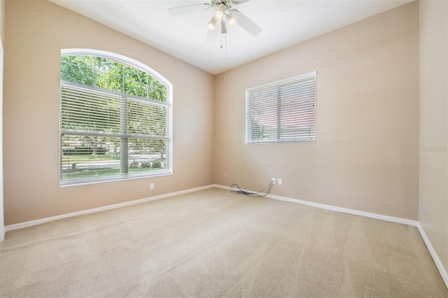 carpeted empty room featuring ceiling fan