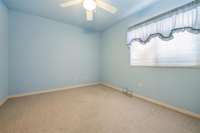 empty room featuring carpet flooring and ceiling fan