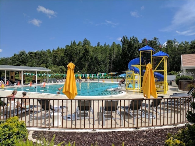 view of pool with a patio area and a water slide