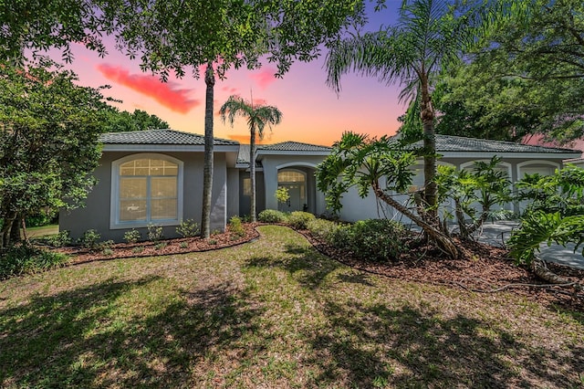 view of front of property with a lawn and a garage