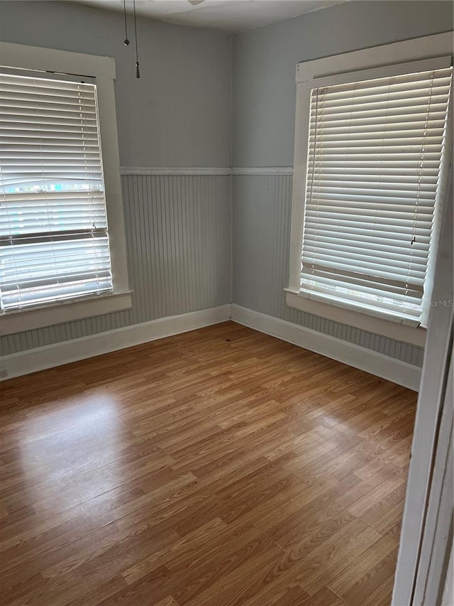 unfurnished room with hardwood / wood-style floors