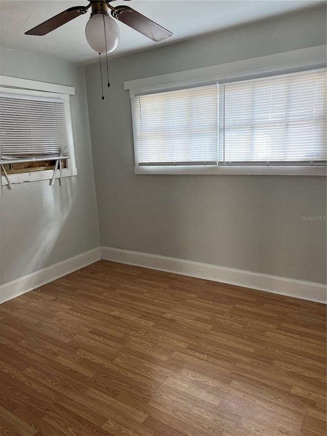 spare room featuring hardwood / wood-style flooring and ceiling fan