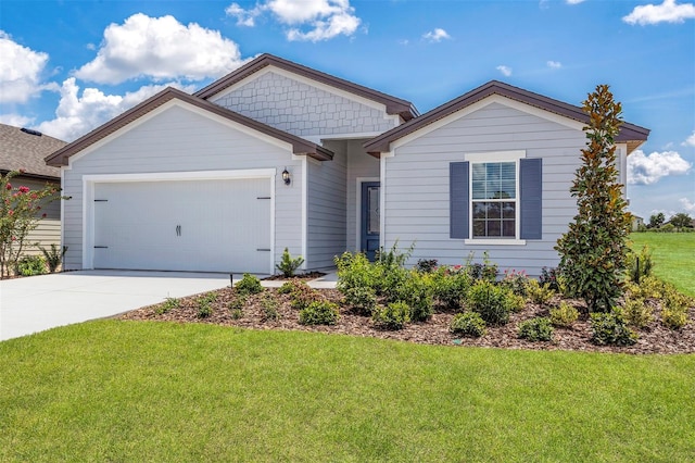 view of front of property with a garage and a front lawn