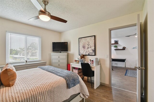 bedroom with wood-type flooring, a textured ceiling, and ceiling fan