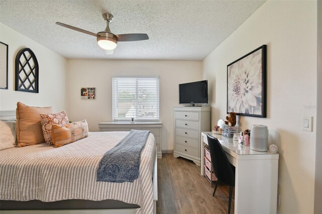 bedroom featuring a textured ceiling, ceiling fan, and dark wood-type flooring