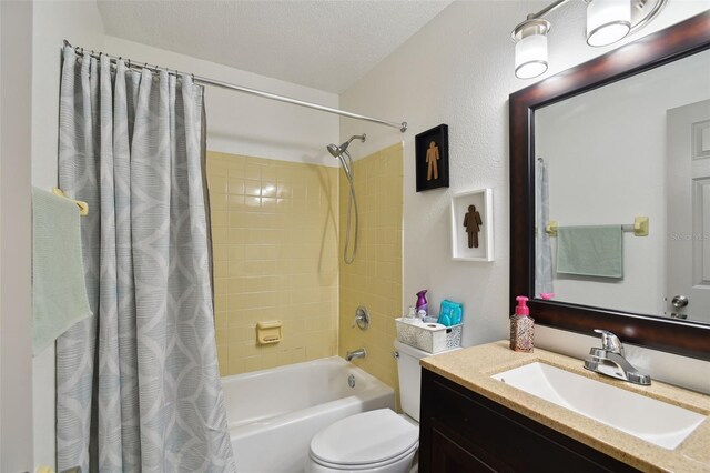 full bathroom featuring vanity, shower / bath combo, a textured ceiling, and toilet