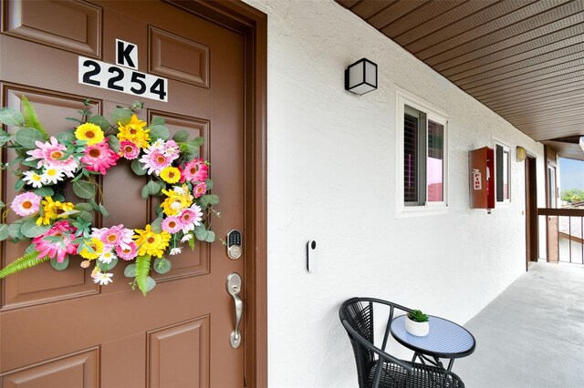 view of exterior entry with a porch