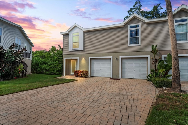 view of front of house featuring a lawn and a garage