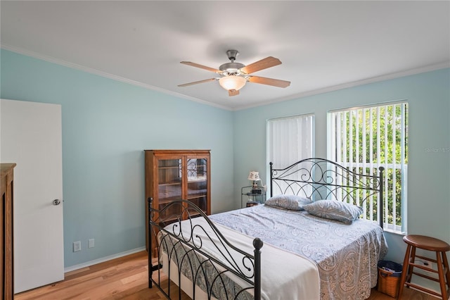 bedroom featuring ceiling fan, light hardwood / wood-style flooring, and ornamental molding