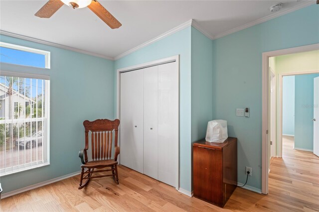 sitting room with ceiling fan, crown molding, and light hardwood / wood-style flooring