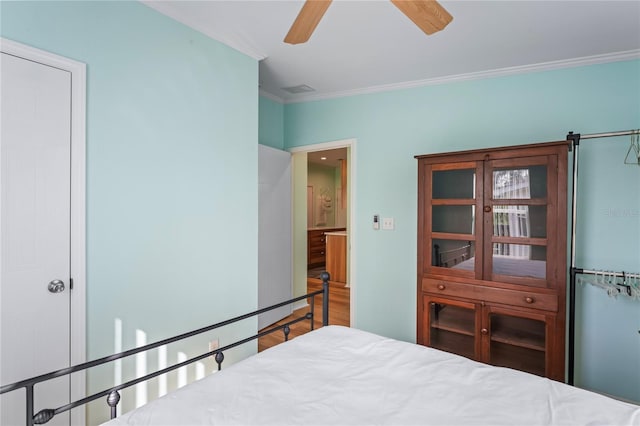 bedroom featuring ceiling fan and ornamental molding