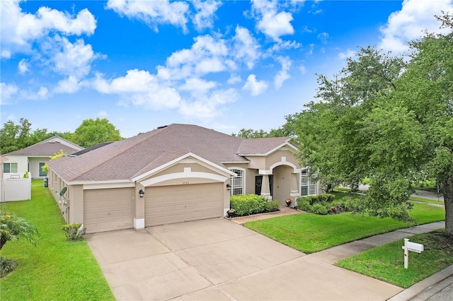 view of front of property featuring a garage and a front lawn