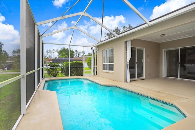 view of pool with a lanai and a patio area