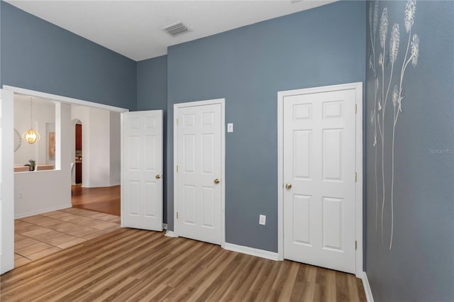 unfurnished bedroom with hardwood / wood-style floors