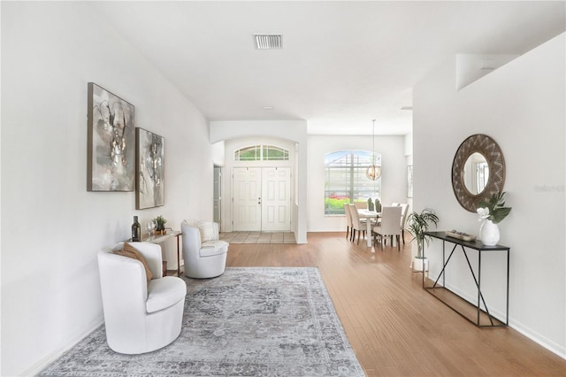 interior space featuring hardwood / wood-style floors and a chandelier