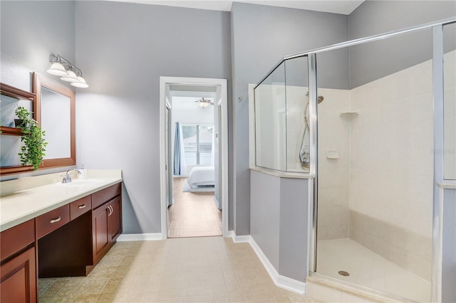 bathroom with vanity, tile patterned floors, an enclosed shower, and ceiling fan