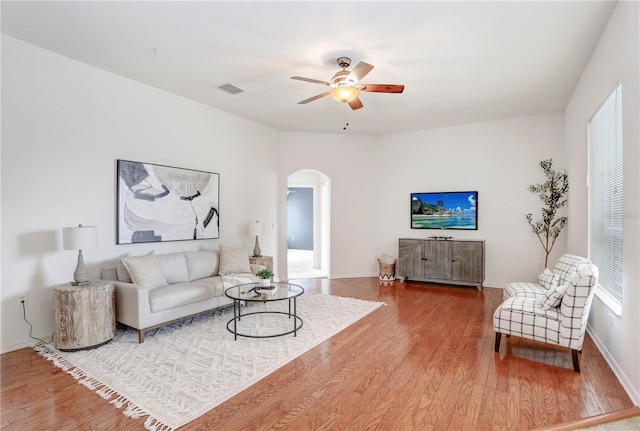 living room with ceiling fan and hardwood / wood-style floors