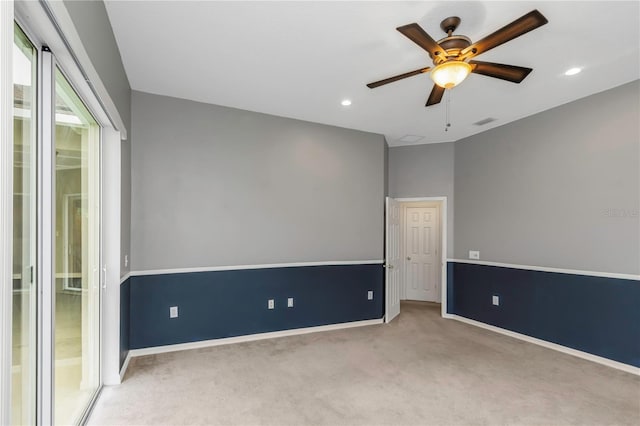 carpeted empty room featuring ceiling fan