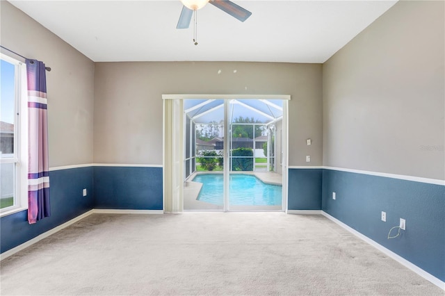 unfurnished room featuring ceiling fan and carpet floors