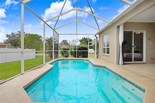 view of swimming pool featuring a lanai, a patio area, and a yard