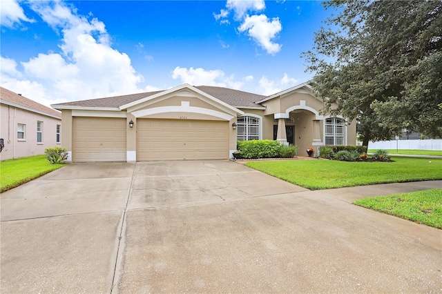 ranch-style home with a front yard and a garage