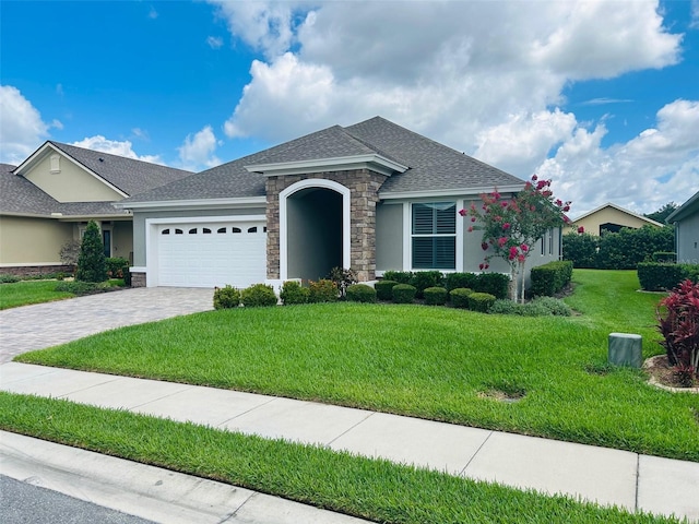 view of front of property with a garage and a front yard