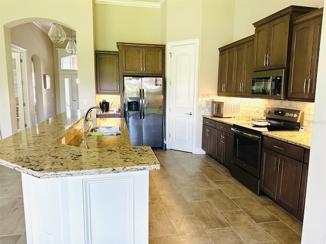 kitchen featuring light stone countertops, appliances with stainless steel finishes, crown molding, and sink