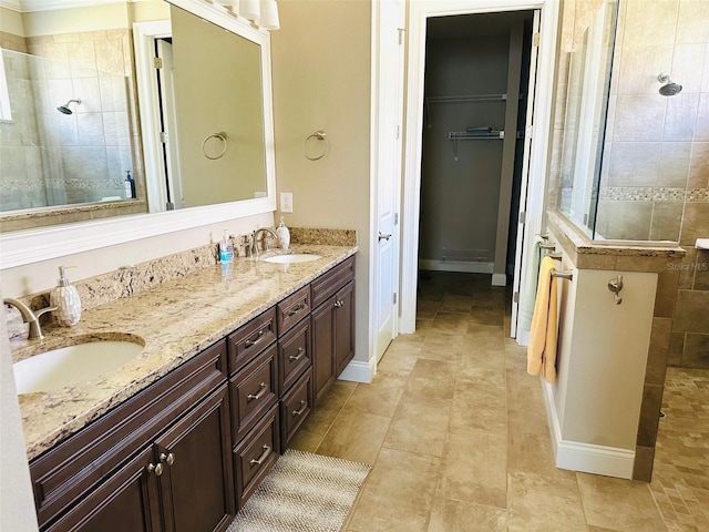 bathroom featuring vanity and tiled shower