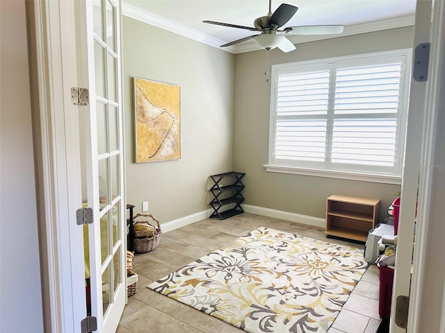 living area with crown molding, baseboards, tile patterned floors, french doors, and a ceiling fan