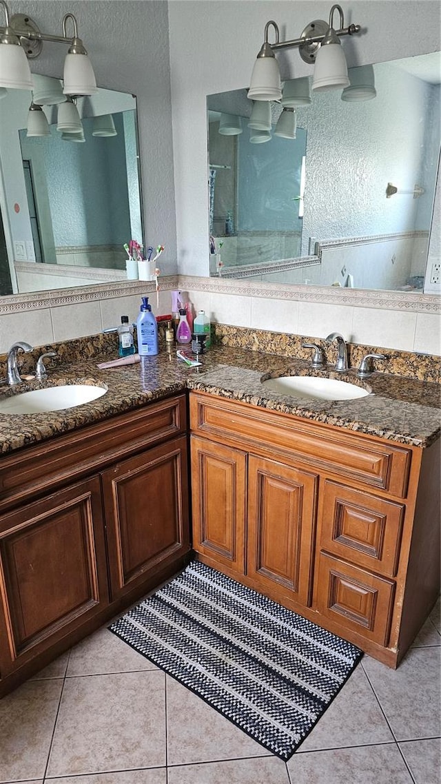 bathroom with tile patterned floors, vanity, and tasteful backsplash