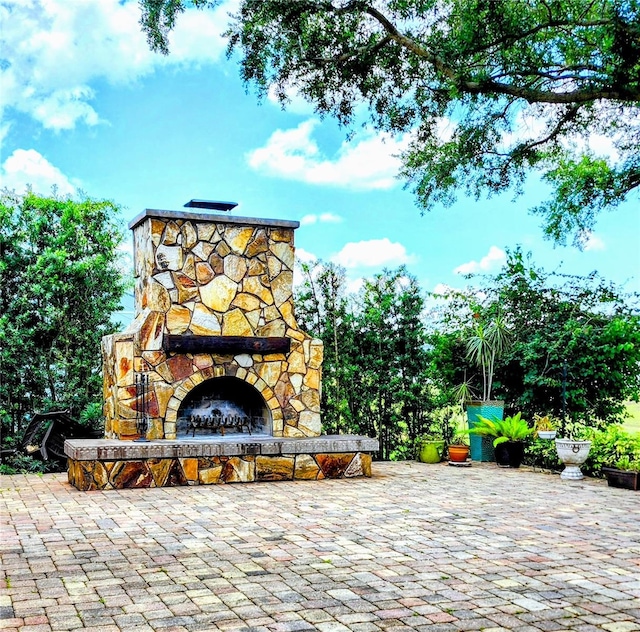 view of patio with an outdoor stone fireplace