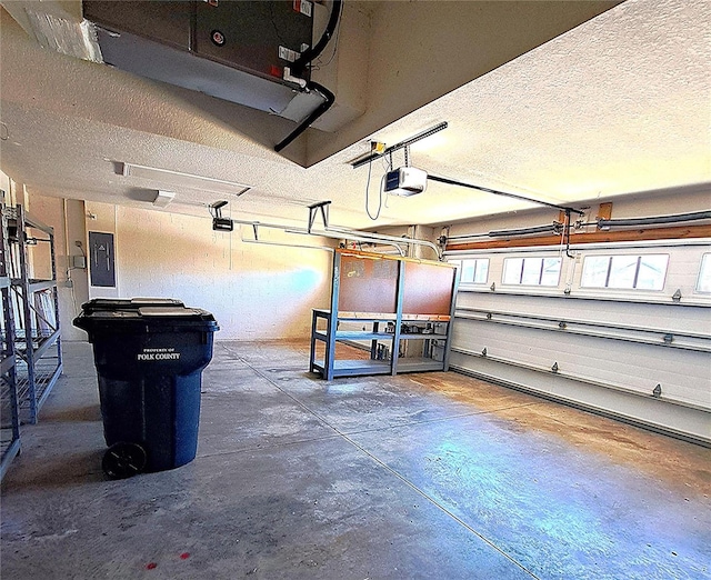 garage featuring a garage door opener and electric panel