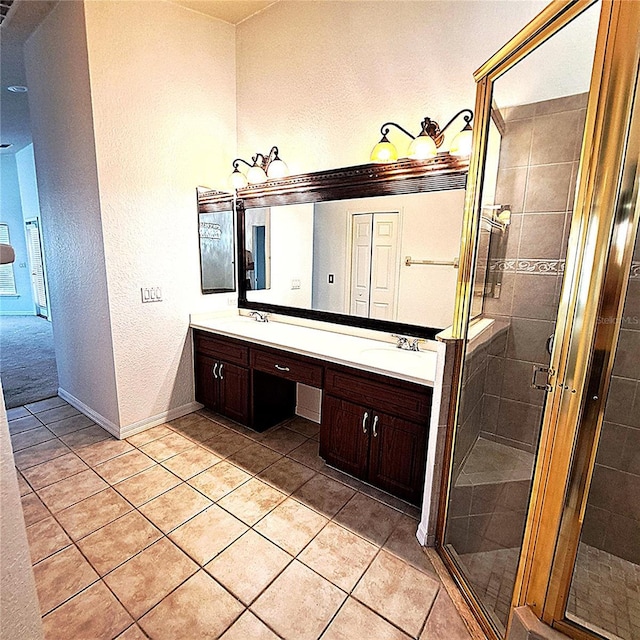 bathroom featuring tile patterned flooring, vanity, and an enclosed shower