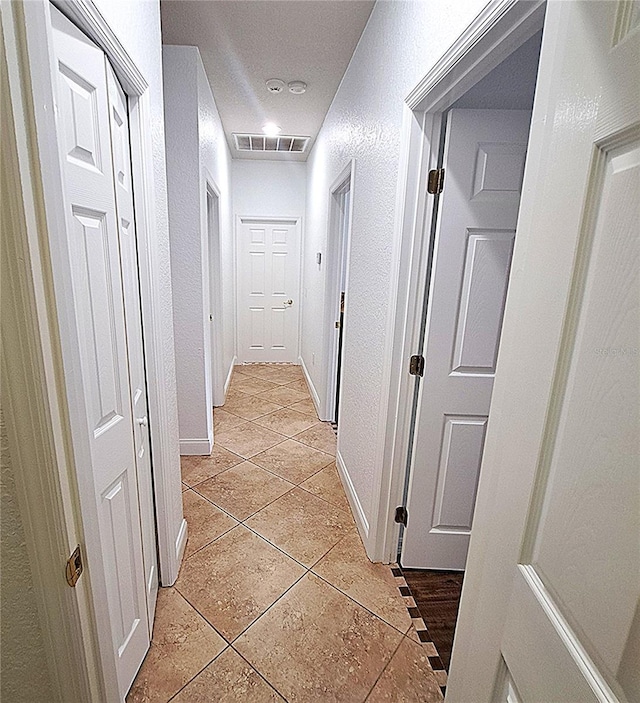 hallway featuring light tile patterned floors