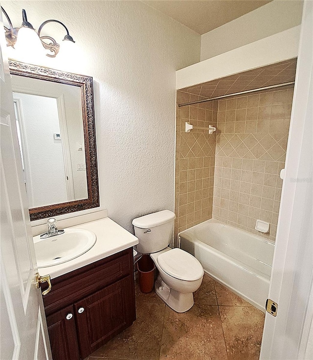 full bathroom featuring vanity, tiled shower / bath combo, tile patterned floors, and toilet