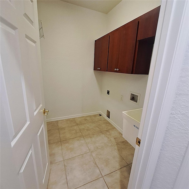 laundry area with electric dryer hookup, washer hookup, cabinets, and light tile patterned flooring