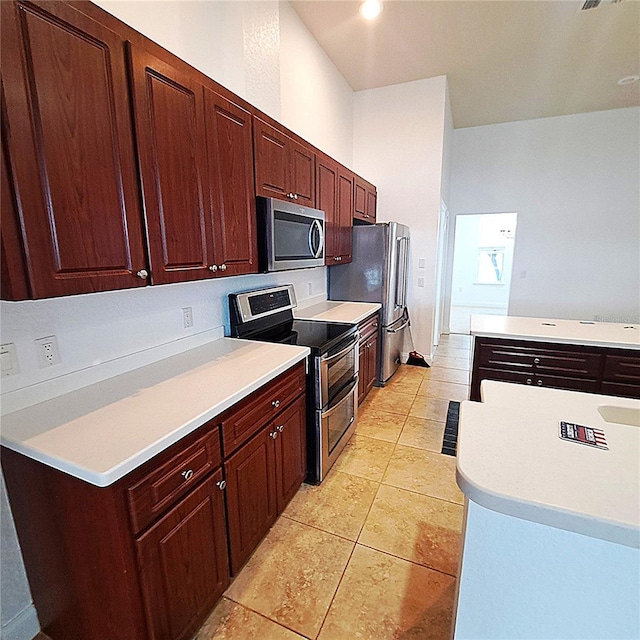 kitchen featuring light tile patterned floors and appliances with stainless steel finishes