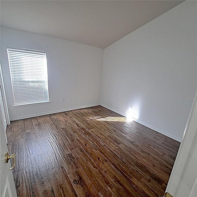 spare room with hardwood / wood-style flooring