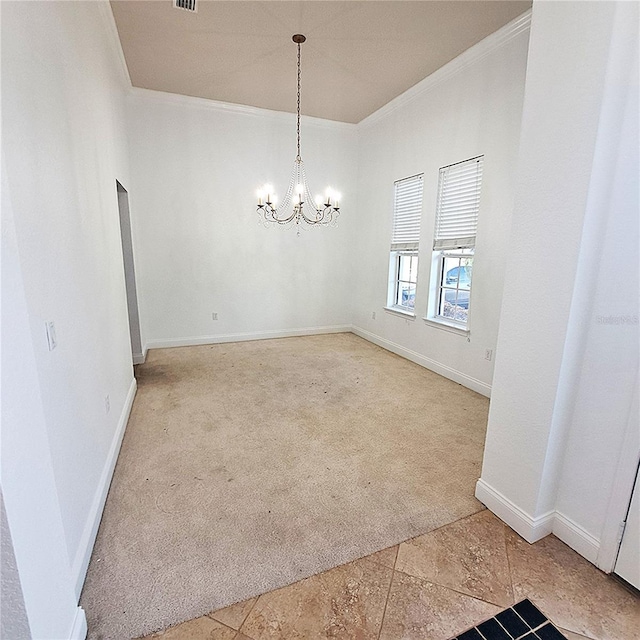 carpeted empty room featuring ornamental molding and a notable chandelier