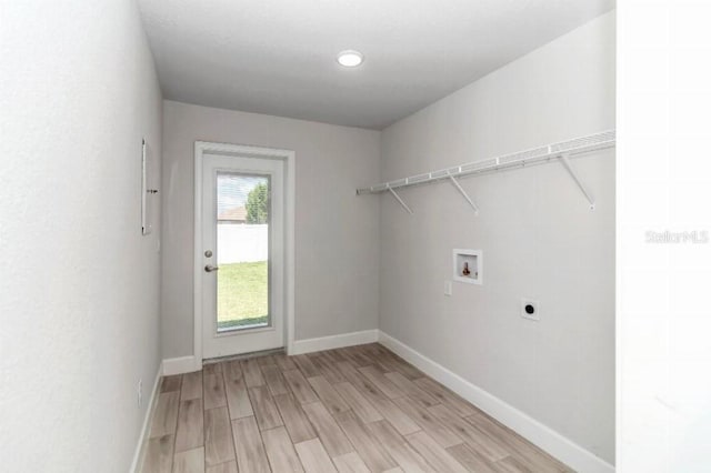 laundry area featuring hookup for a washing machine, light wood-type flooring, and hookup for an electric dryer