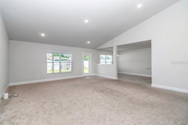 empty room featuring carpet and lofted ceiling