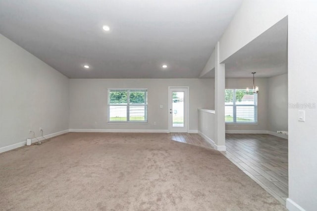 empty room featuring light hardwood / wood-style flooring and vaulted ceiling