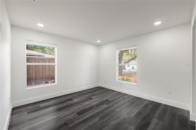 spare room with dark hardwood / wood-style flooring