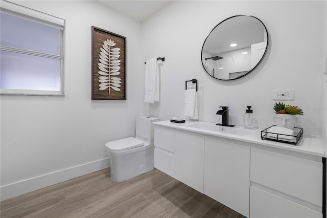 bathroom featuring vanity, toilet, and a shower