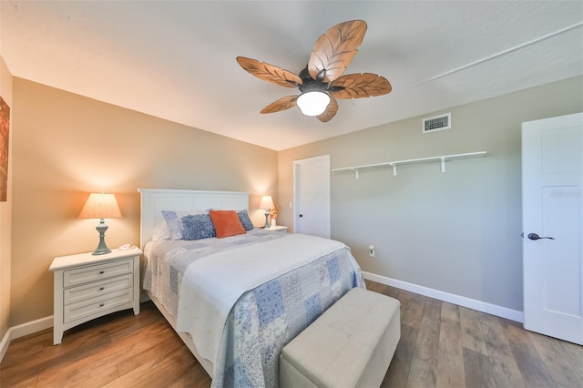 bedroom featuring hardwood / wood-style flooring, ceiling fan, and a closet