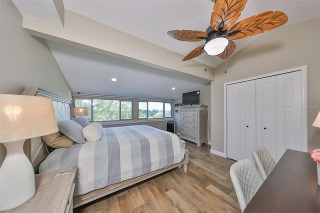 bedroom featuring a closet, ceiling fan, vaulted ceiling, and light hardwood / wood-style flooring