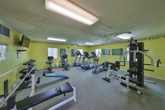 exercise room featuring ceiling fan and a textured ceiling